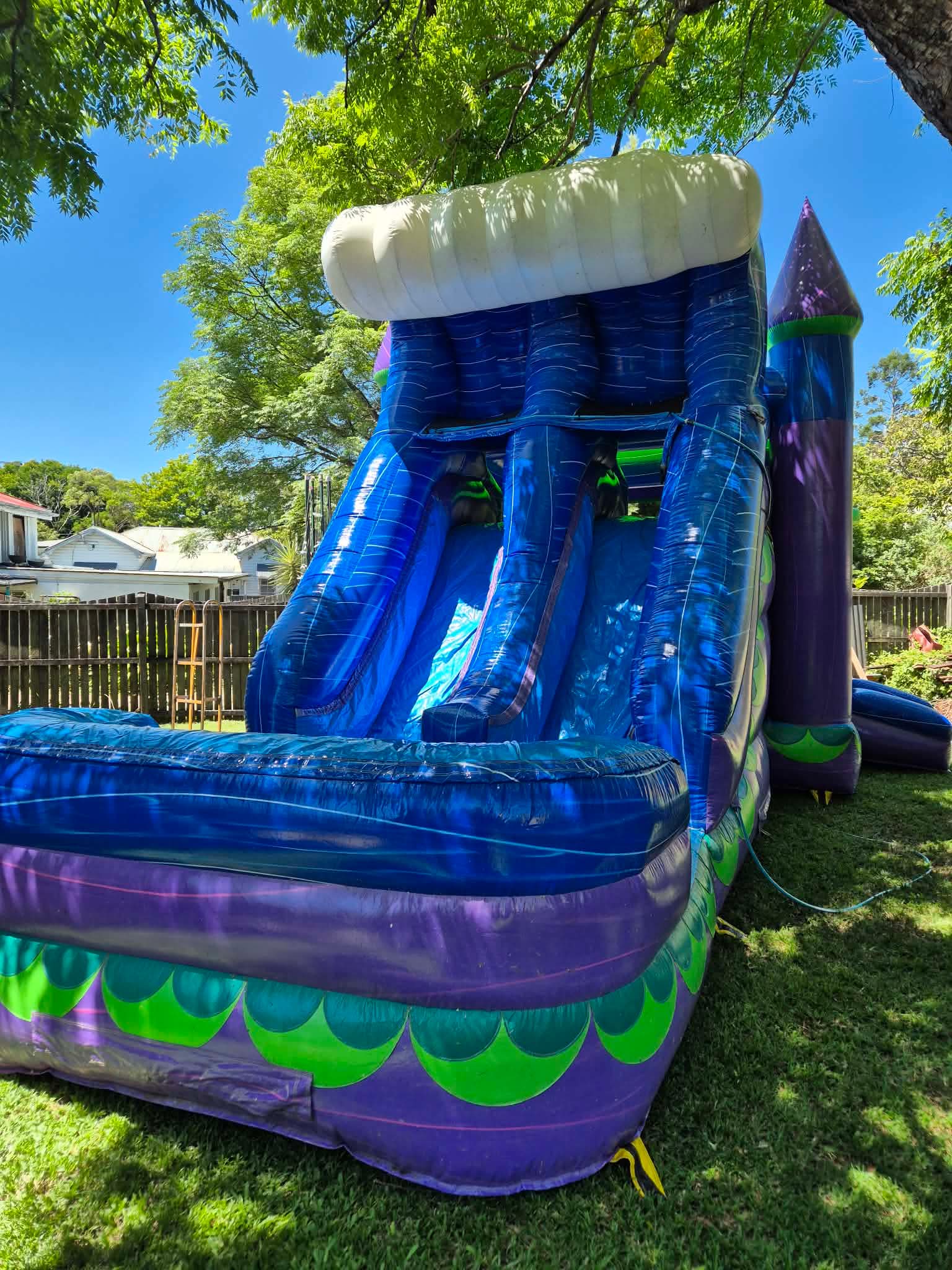 Blue and purple inflatable waterslide with splash pool